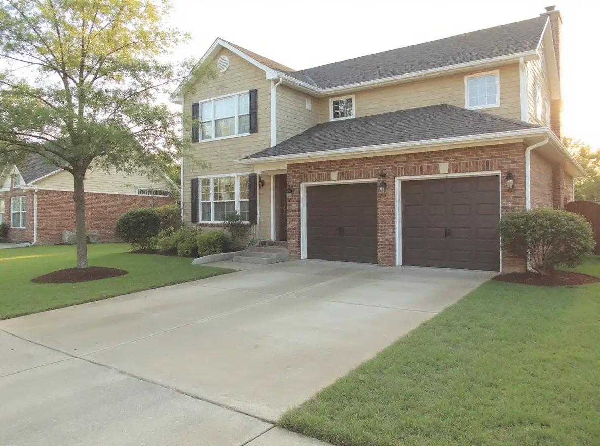 Three-car concrete driveway brick home — Ford Concrete design idea