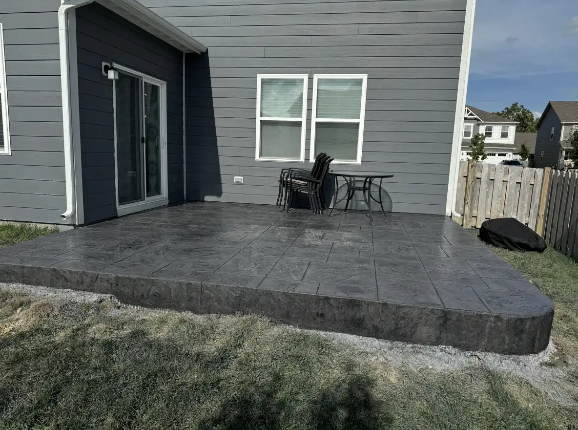 Stamped concrete patio with slate pattern in charcoal — Ford Concrete, Kansas City