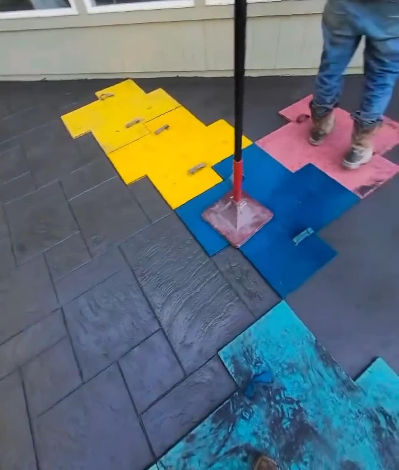 Stamped concrete installation crew Kansas City — applying stamp mats | Ford Concrete